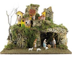 Sfeervol verlicht dorpslandschap met geboortescène en decoratieve huizen